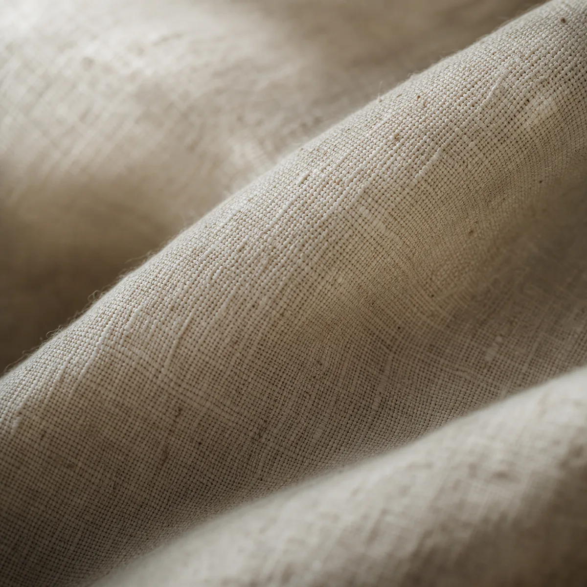 The warp and weft of an undyed woven cloth, close up.