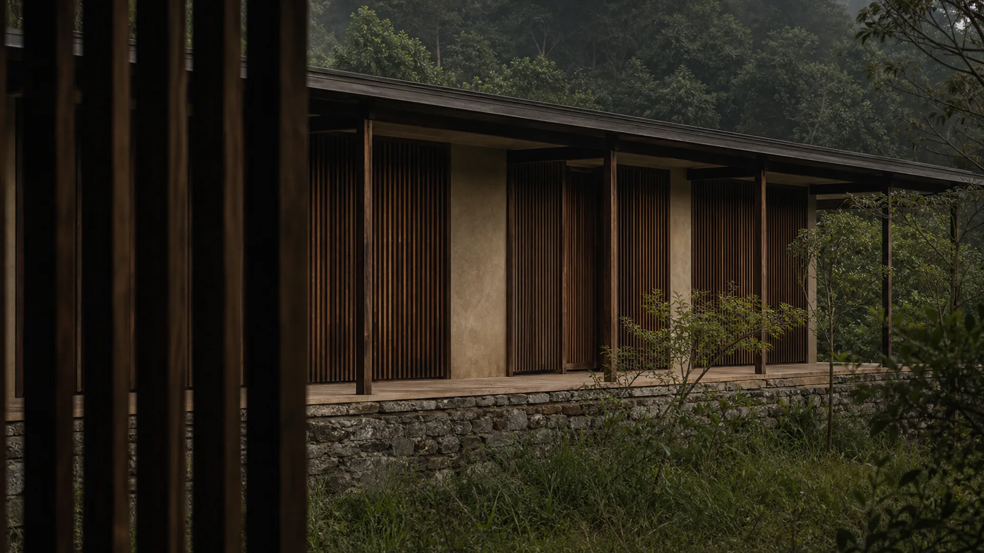 The long elevation of the house, timber screens running the length of the terrace.