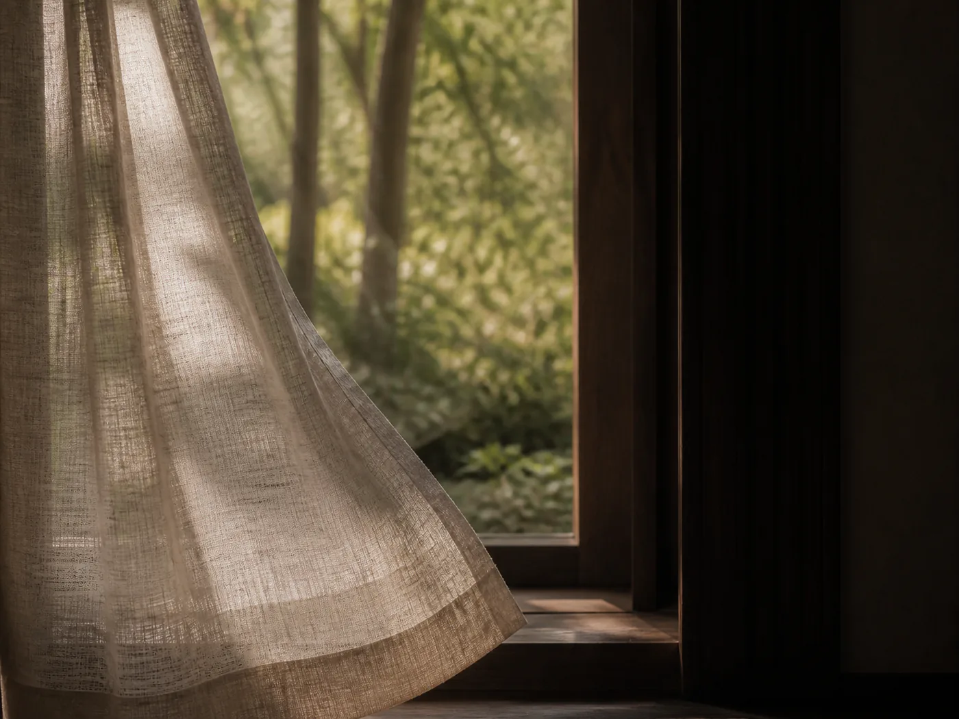 Morning light behind a linen curtain.