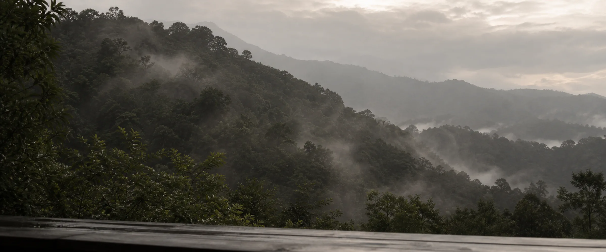 Layered ridgelines with cloud draining out of the side valleys at first light.